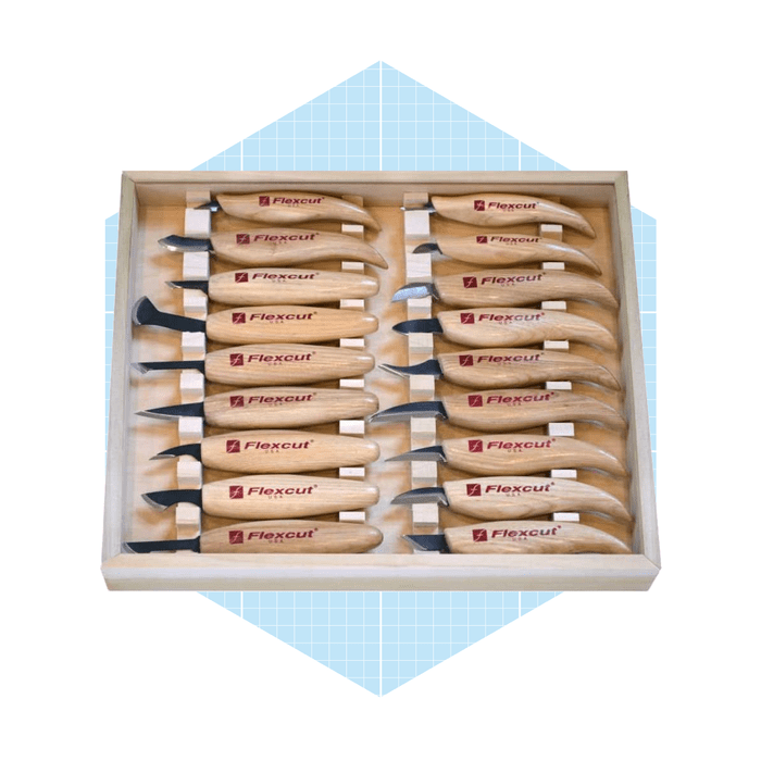 A wooden tool tray holds various carving knives with curved blades, showcasing their wooden handles engraved with 