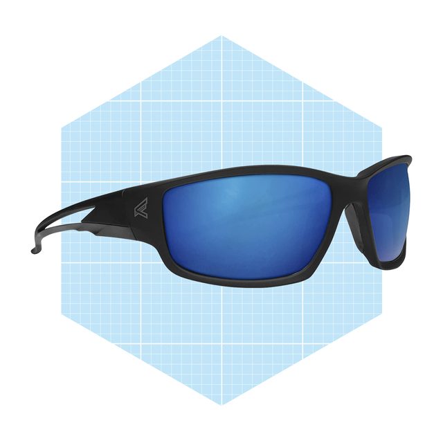 Black sunglasses with blue lenses rest against a light blue grid-patterned background, showcasing a sleek and modern design.