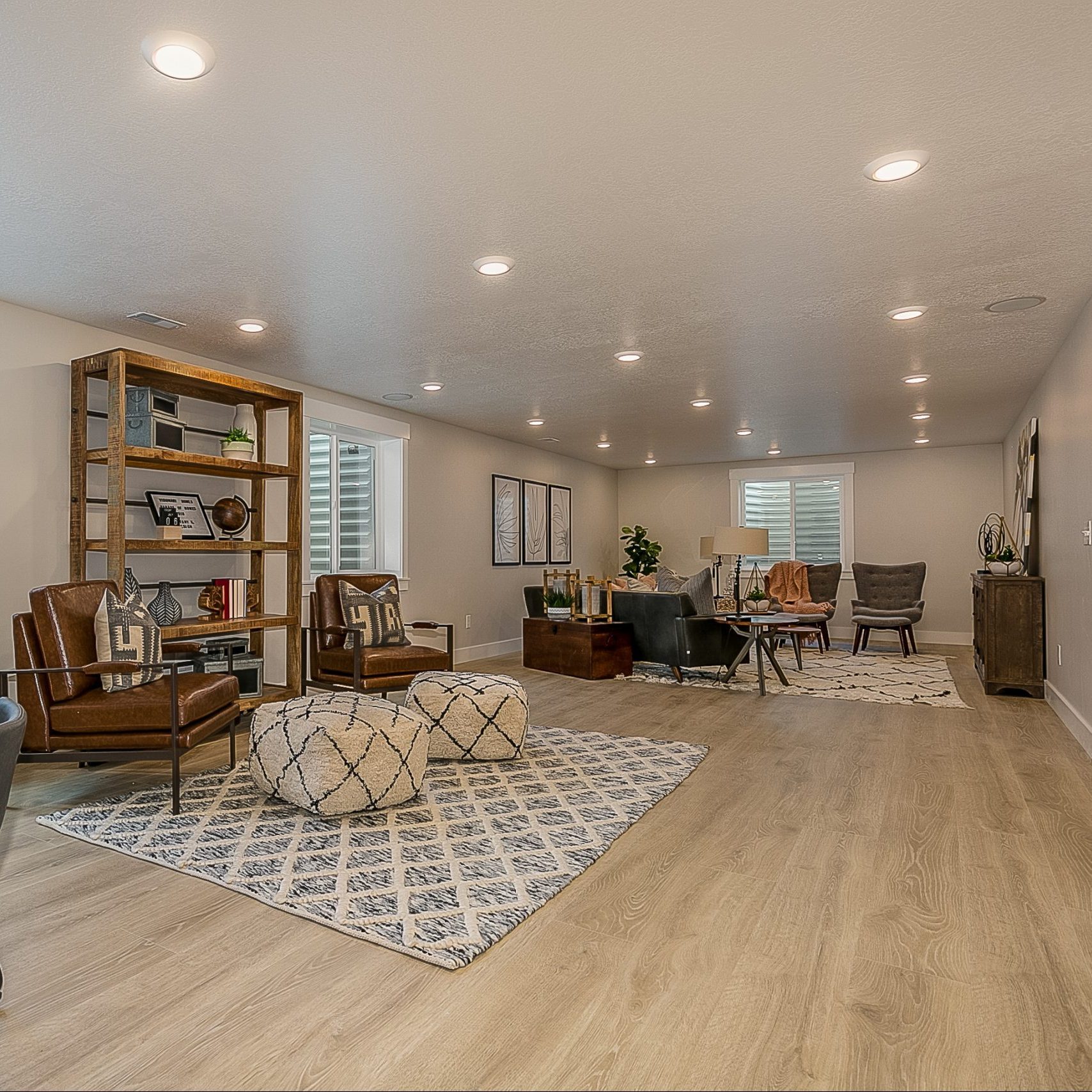 Wood flooring in basement rec room area with a lot of space