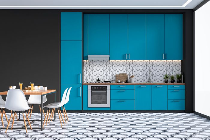 Modern kitchen and dining room on retro tiled floor
