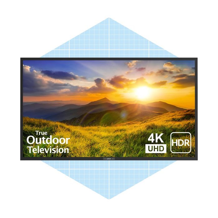 A television displays a vibrant sunset over rolling hills and grassy fields, highlighting features like 4K UHD and HDR suitability for outdoor use.