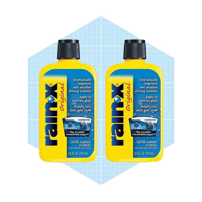 Two bottles of Rain-X, a glass treatment product, are displayed against a blue grid background. They claim to improve visibility in wet weather.