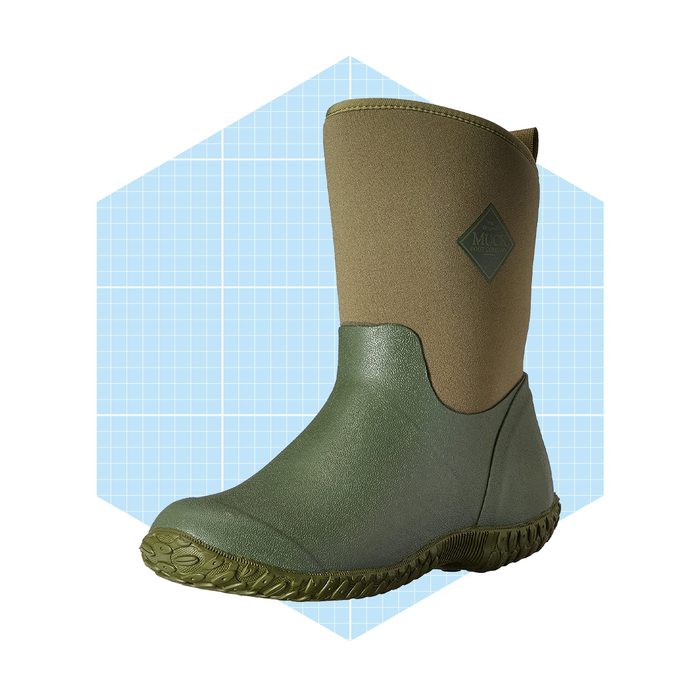 A green boot stands upright with a textured sole, showcasing its water-resistant design against a light blue grid background.