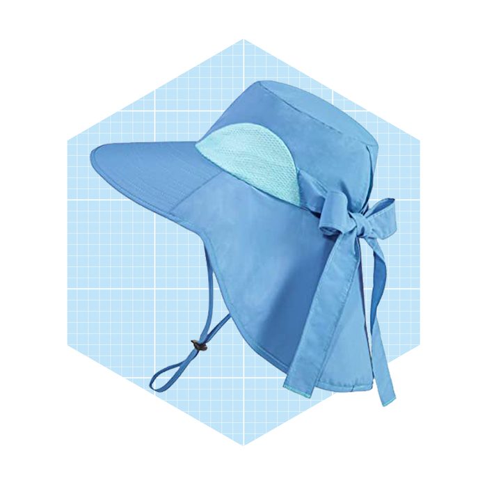 A blue sun hat with a wide brim and tie, designed for shade and protection, sits against a light blue grid background.