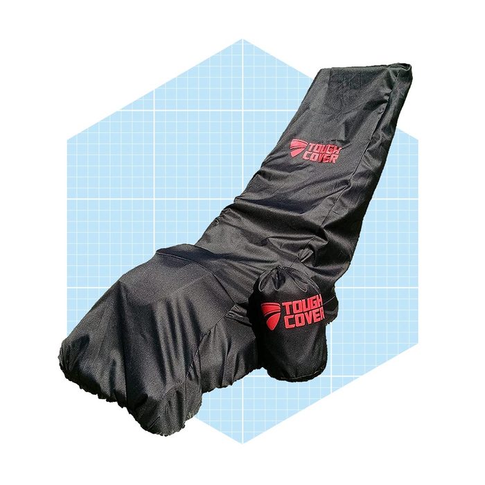 A black outdoor chair cover is draped over a reclining chair, protecting it from the elements against a light blue grid background.