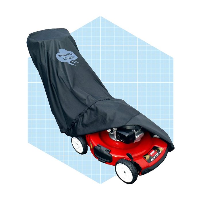 A red lawn mower is covered with a black protective cover, sitting on a light blue grid background.