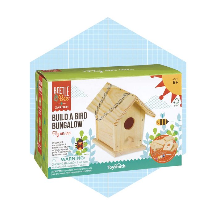 A colorful box contains materials to build a birdhouse, featuring a wood structure and accessories, designed for children aged 5 and up.