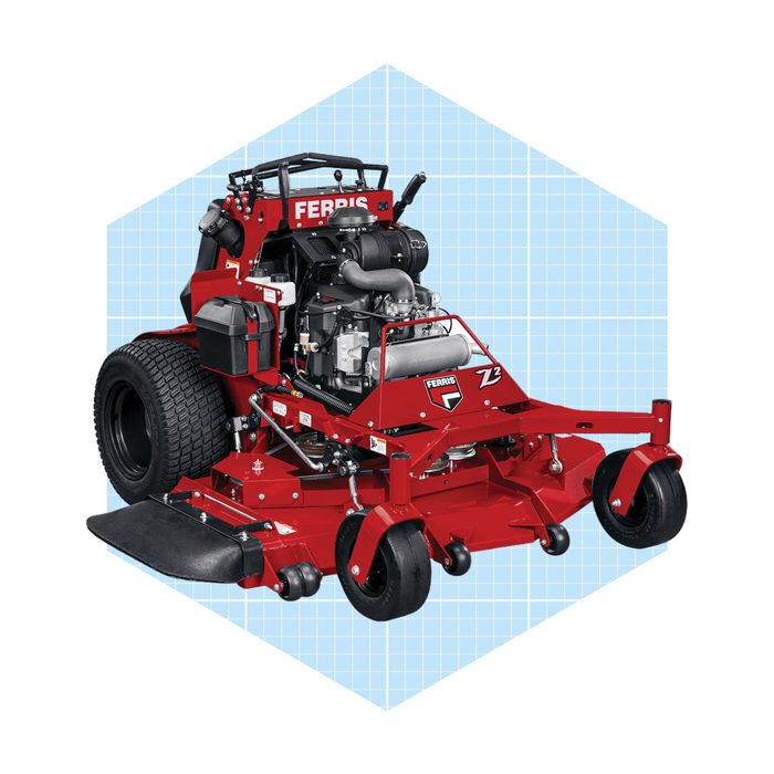 A red zero-turn lawn mower stands upright, showcasing its engine and large rear wheels against a blue grid background.