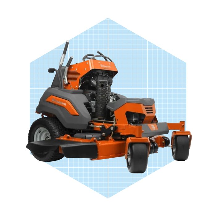 A riding lawn mower is displayed, featuring an orange and gray design, positioned against a light blue grid background, ready for cutting grass.