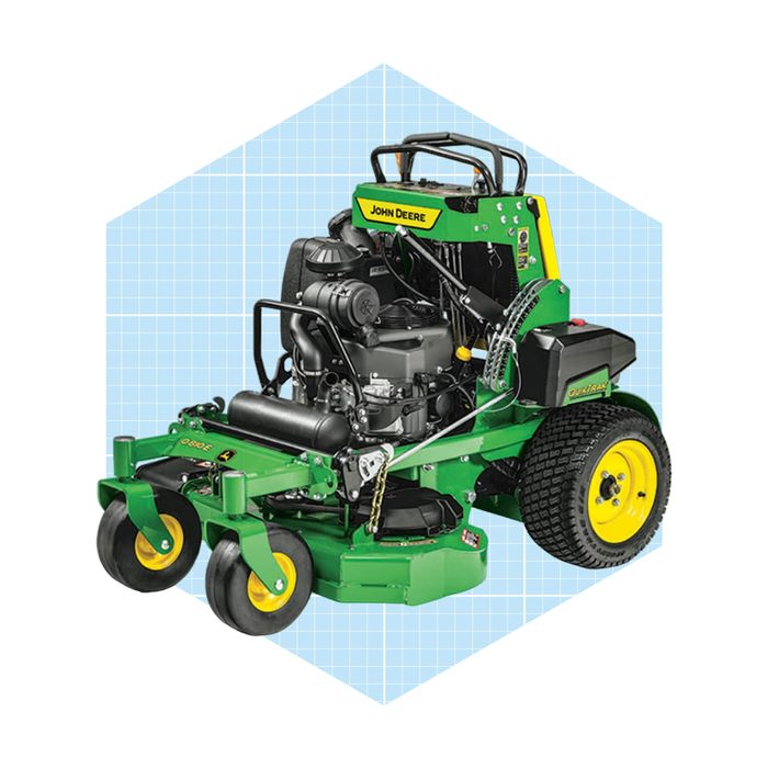 A green and yellow lawn mower with a visible engine operates on four wheels, set against a light blue grid background.