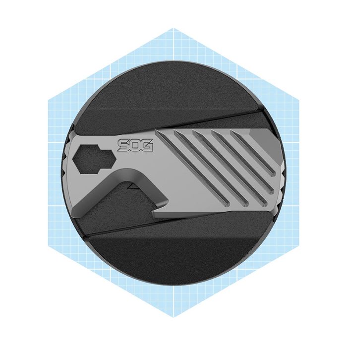 A sleek, metallic tool features a cutting edge and hexagonal design, placed on a circular black surface with a light blue grid background.