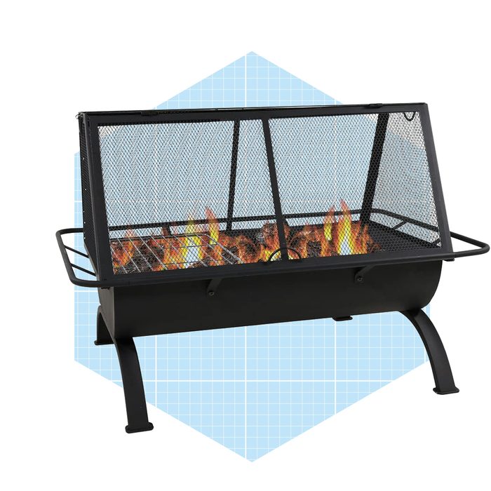 A black fire pit with a mesh cover burns bright flames, providing a warm ambiance, set against a light blue geometric background.