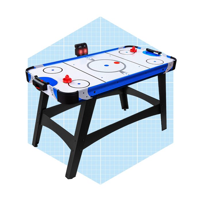 A rectangular air hockey table features red and blue paddles, a scoring device, and a smooth playing surface, set against a light blue background.