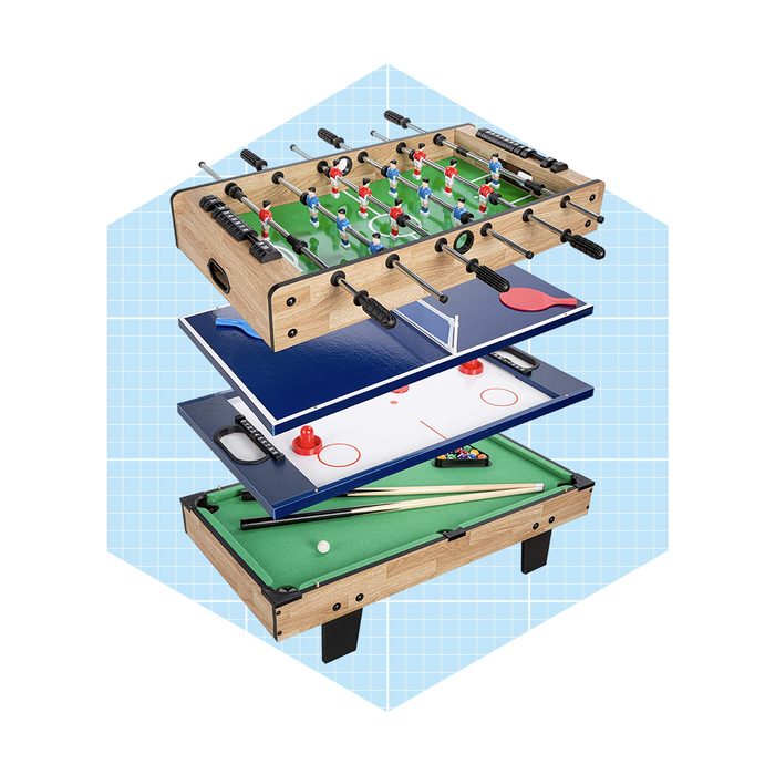A multi-game tabletop features foosball, air hockey, and pool components, stacked with visible playing surfaces and accessories against a light blue grid background.