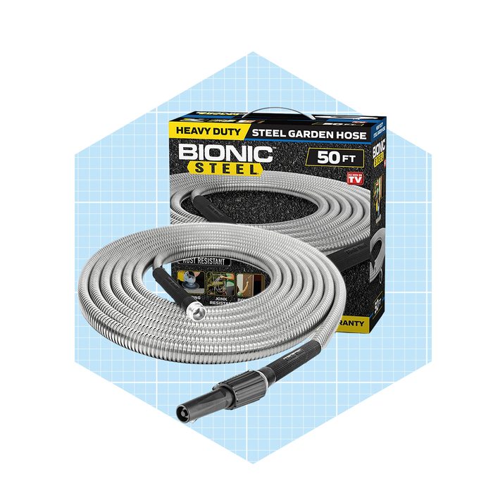 A coiled, heavy-duty steel garden hose sits next to its packaging, showcasing features like rust resistance against a light blue grid background.