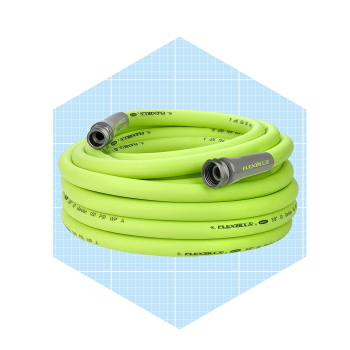 A coiled, bright green garden hose lies neatly, crafted with sturdy connectors, set against a light blue grid background, suggesting a clean, organized display.