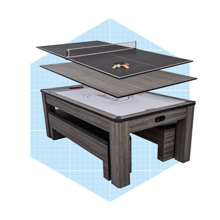 A multi-functional table displays a detachable ping pong surface above a game table, set against a light blue grid background.