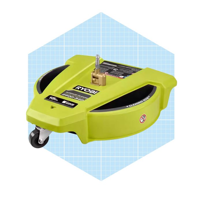 A round, green power washer attachment rests on a light blue grid background, designed for cleaning surfaces efficiently with rotating nozzles.