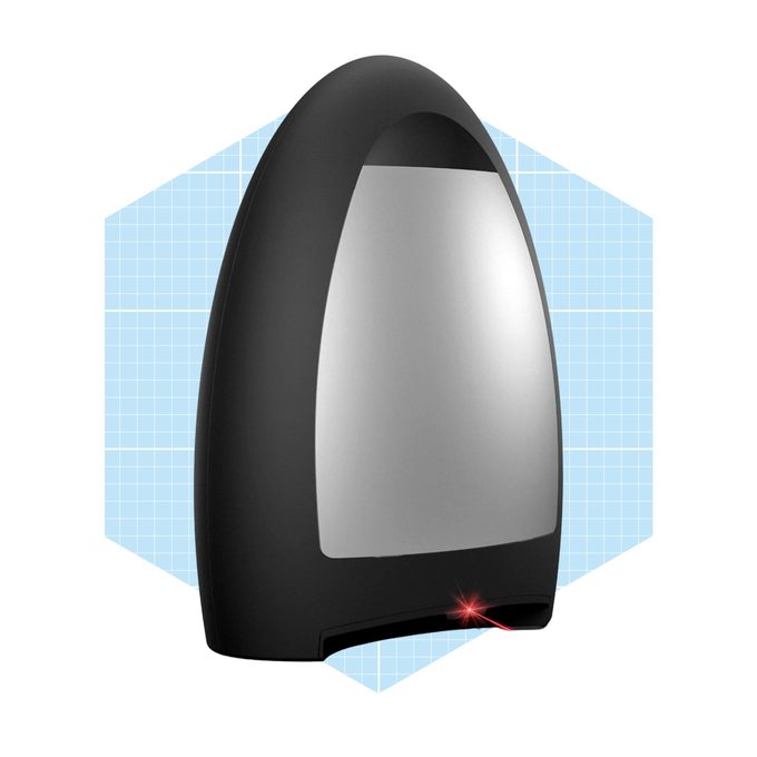 A sleek, black device with a reflective surface emits a red laser beam, set against a light blue, grid-patterned background.