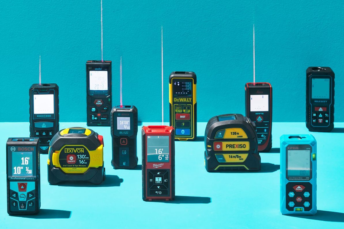 Various laser distance measuring tools stand upright on a bright turquoise surface, each displaying different measurement readings.