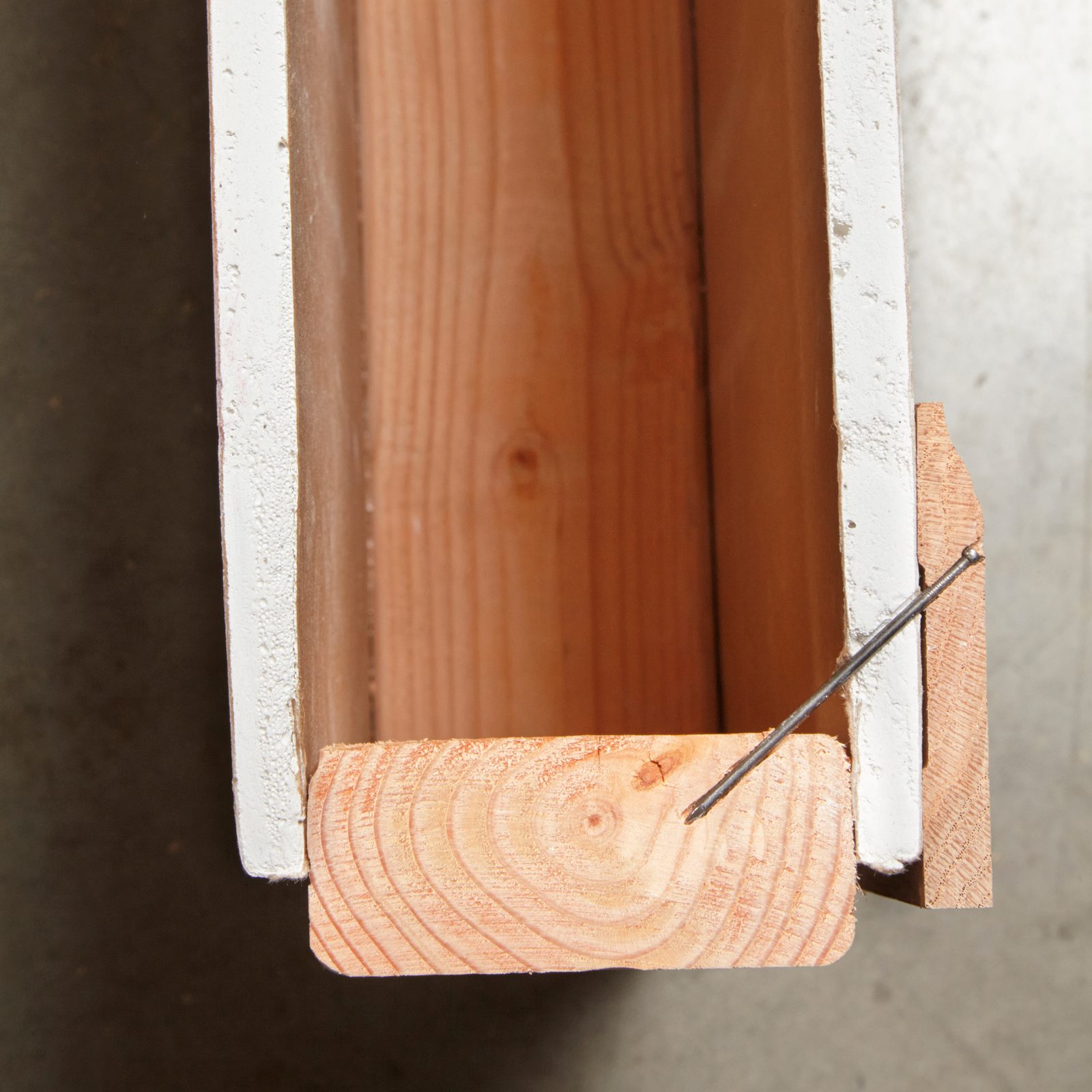 Angle a Nail to Close Baseboard Gaps