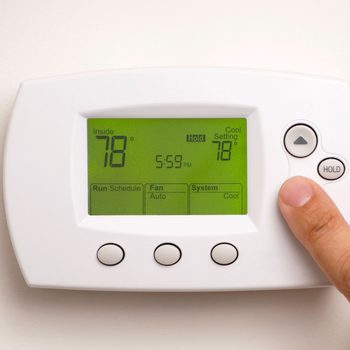 A thermostat displays 78°F inside and in cooling mode, while a finger adjusts the setting, indicating it's 5:59 PM.