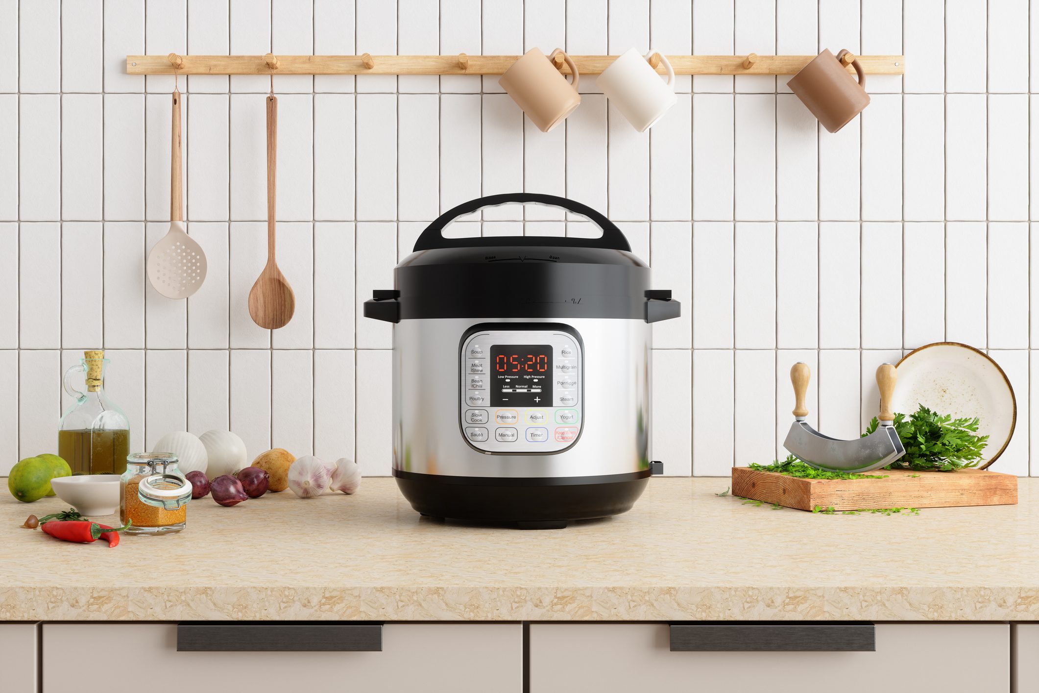 A stainless steel multi-cooker sits on a countertop, surrounded by cooking ingredients and utensils, with a white tiled wall in the background.