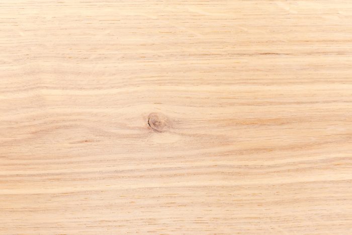 Texture of the light colored oak plank with small knot
