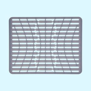 A gray silicone mat with a grid pattern rests flat against a light blue background. It is designed to provide a non-slip surface for various uses.