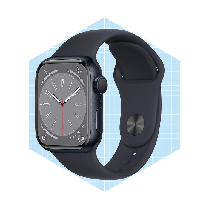 A smartwatch with a black strap displays a gray clock face showing time, positioned on a light blue geometric background.
