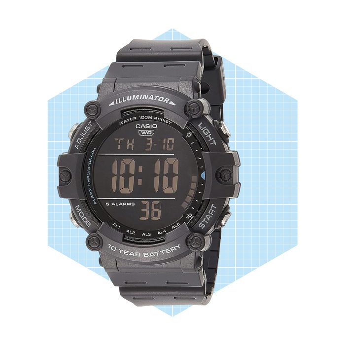 A black digital wristwatch displays time and functions, set against a light blue geometric background. Features include an alarm, water resistance, and a long battery life.