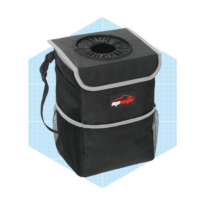 A black storage bag with a top opening and mesh side pockets stands against a light blue grid background, designed for car organization.