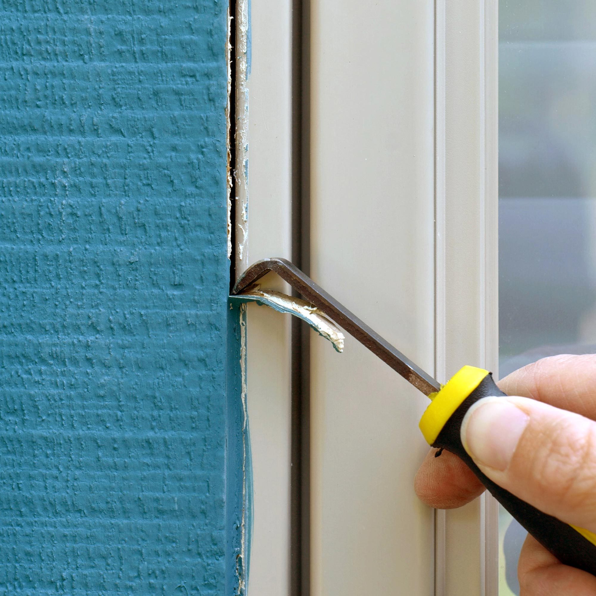 Scraping off the old caulk with a utility knife