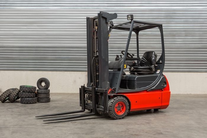 Forklift machinery parked in warehouse