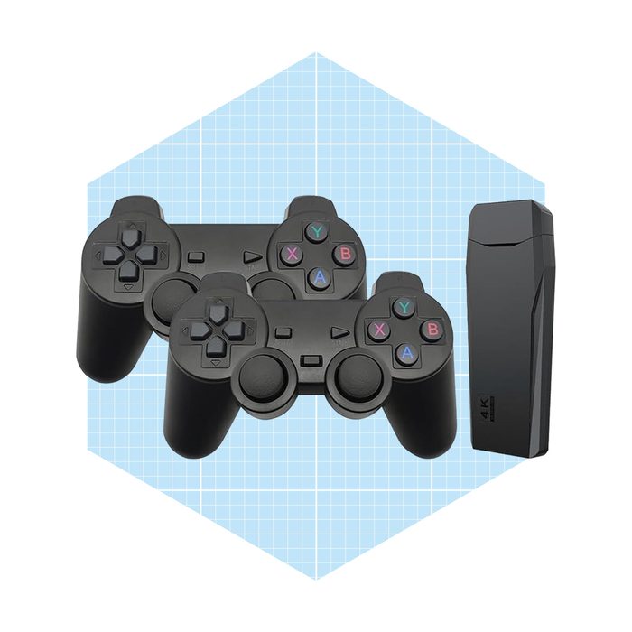 Two black gaming controllers are positioned side by side next to a sleek black device, set against a light blue grid background.