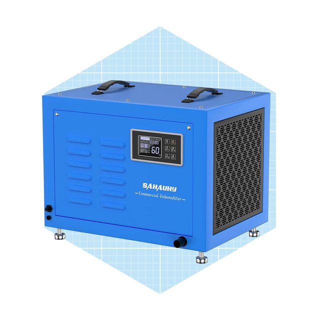 A blue commercial dehumidifier sits on a surface, displaying a digital control panel with settings, designed to reduce humidity in various environments.