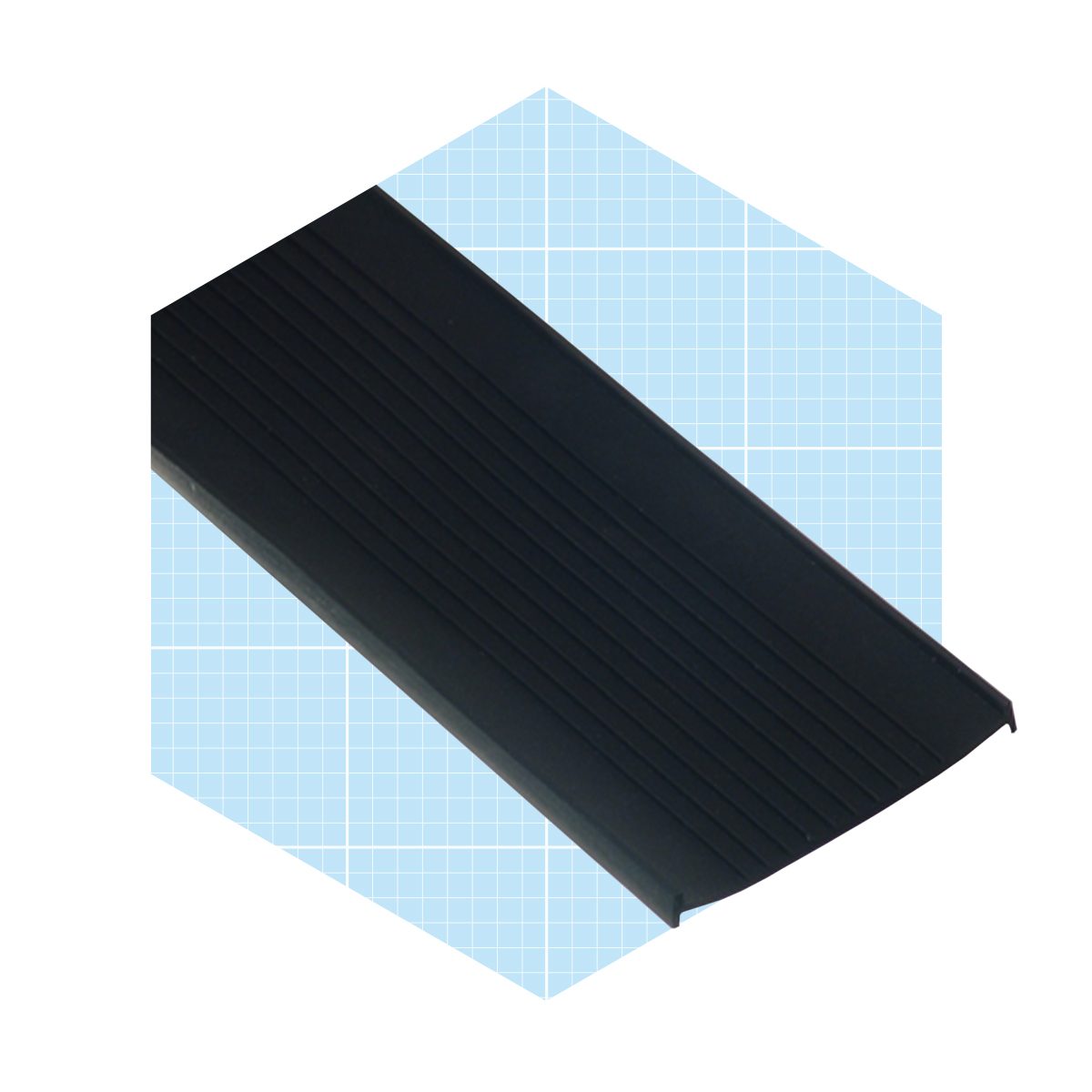 A black rubber mat with ridges is positioned on a light blue, grid-patterned background, suggesting use for traction or to absorb moisture.