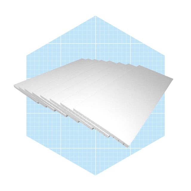 A stack of white sheets is resting at an angle on a light blue grid-patterned background. The sheets appear flat and uniform in shape.