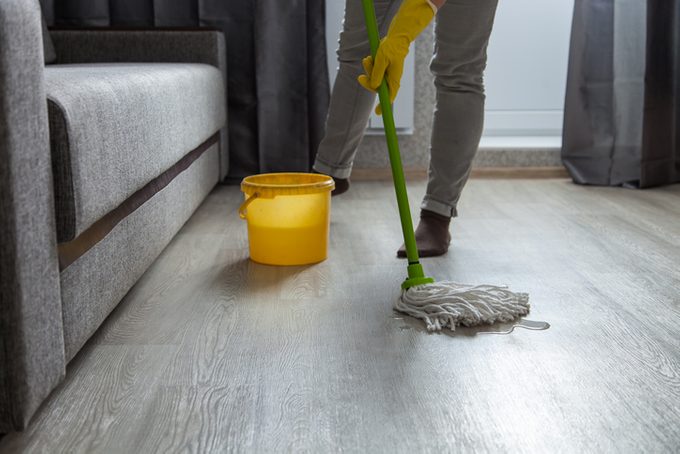 Cleaning Hardwood Floors with a Bucket and Mop for a House Cleaning Concept