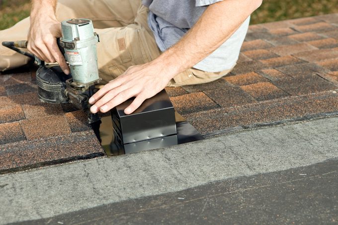 Roofer Nailing Bathroom Vent to New Roof
