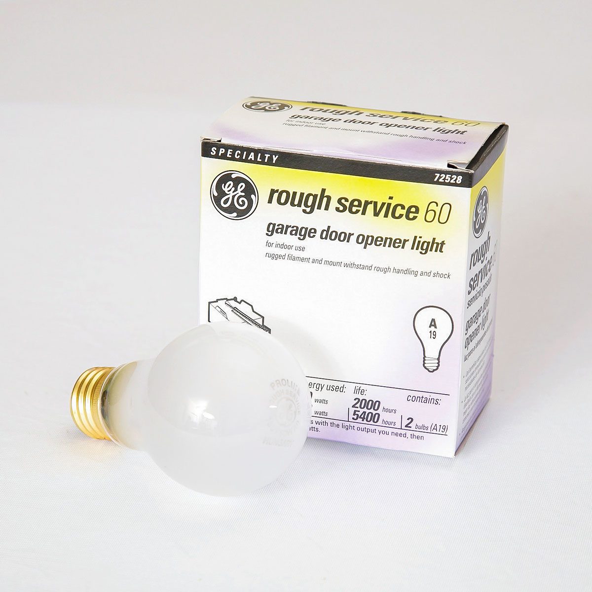 A round light bulb rests beside its box, labeled "GE rough service 60 garage door opener light," indicating it’s designed for indoor use and durability.