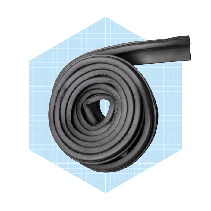 A coiled, black rubber strip sits centrally, suggesting use for sealing or cushioning, against a light blue grid-patterned background.