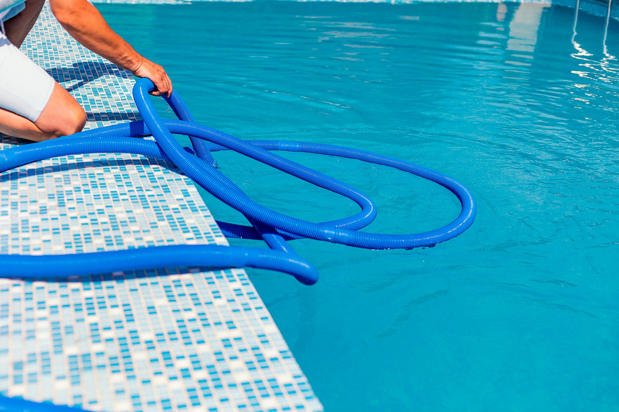 Man cleaning the swimming pool