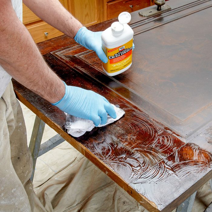Worker Cleaning Wood to Paint