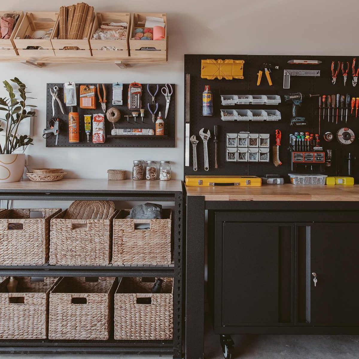 A workshop features organized tools on a wall, a wooden workbench, and storage baskets filled with various items, surrounded by a minimalistic design.