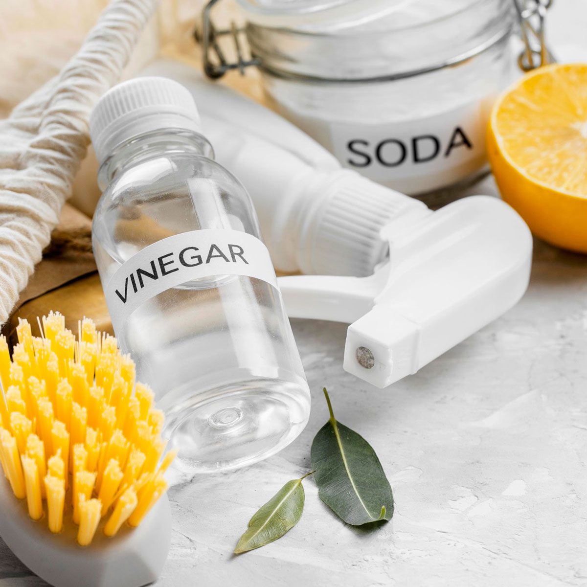 High Angle Eco Friendly Cleaning Brushes And Spray Bottle With Vinegar Lemon And Soda