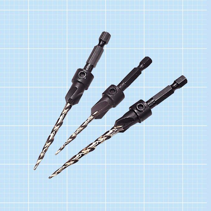 Three countersink drill bits on a blue grid background