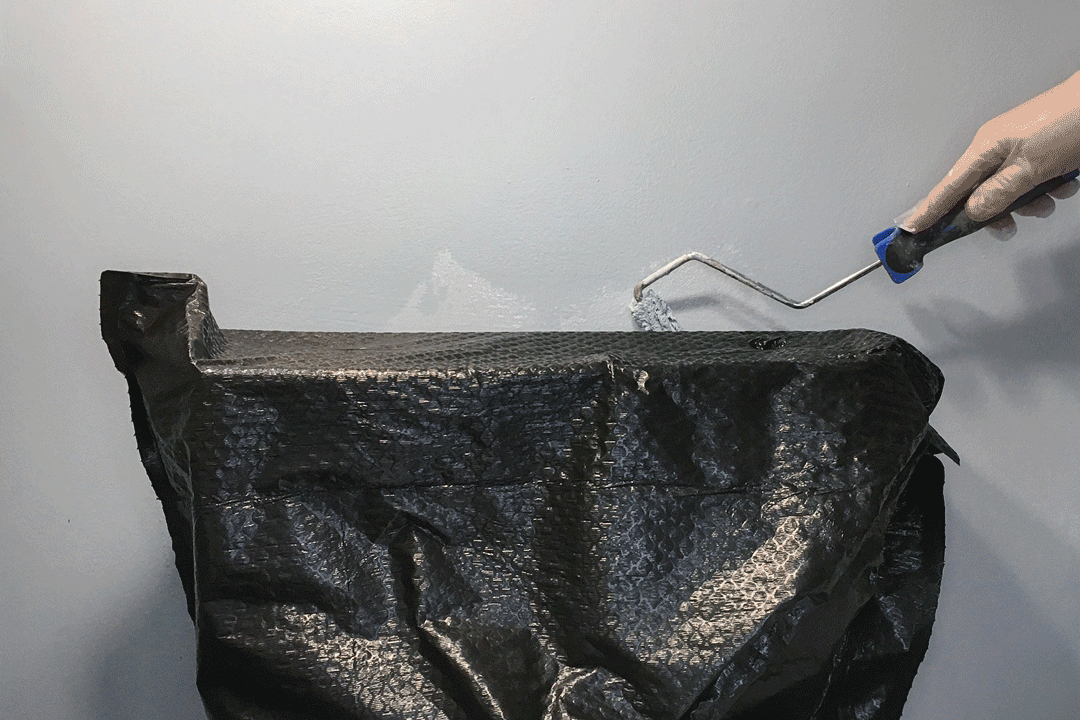 Painting the wall behind toilet with brush roller