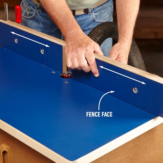 A man working on making a fence face on a woodworking table.