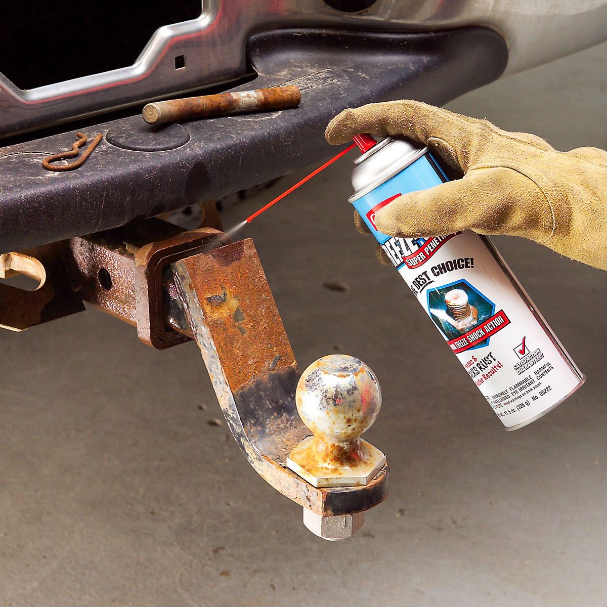 Spraying The Rust Remover Spray On Trailer Hitch's Joint